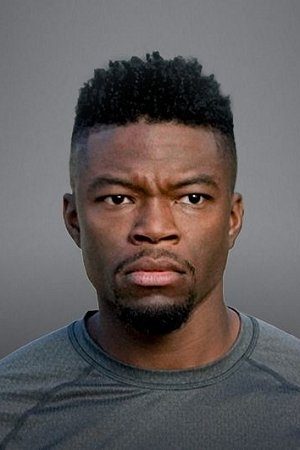 Headshot of Caleb Castille against a grey background