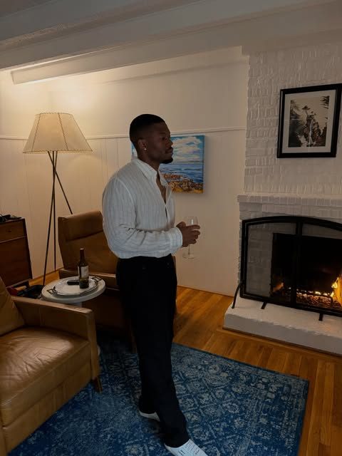 Caleb Castille standing in a warmly lit living room