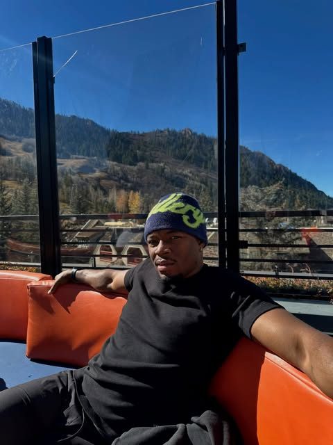 Caleb Castille relaxing on a mountain terrace