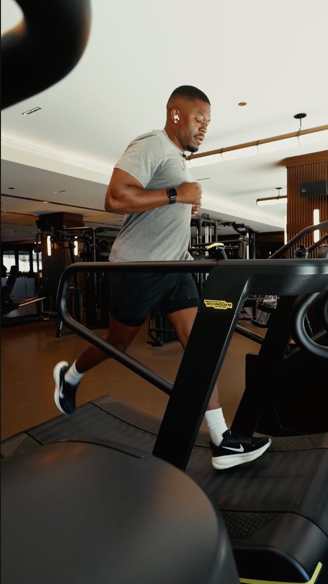 Caleb Castille running on a treadmill in a gym